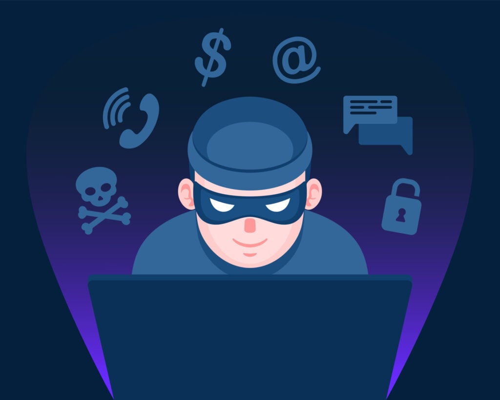 a masked criminal committing a cyber crime.